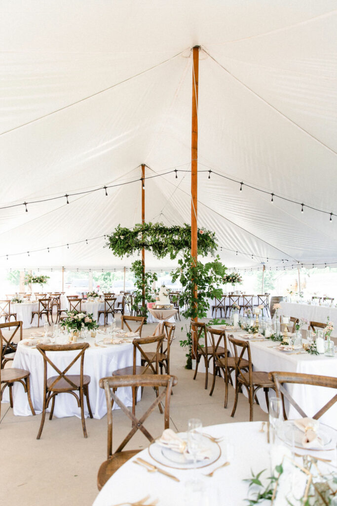 Reception greenery hoop installation above the dance floor to complete soft dreamy wedding.